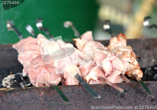 Image of BBQ on skewers with raw shish kebab.