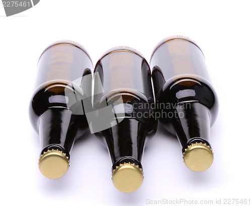 Image of Lying three bottles of beer on white background.