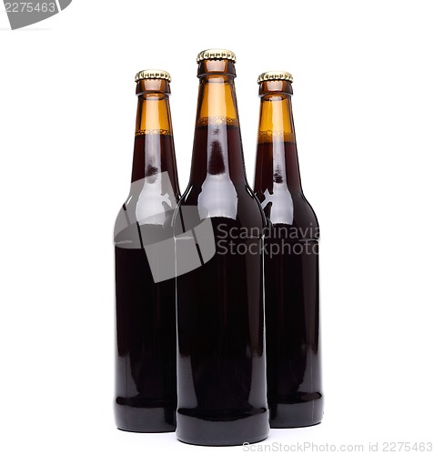 Image of Three bottles of beer on white background.