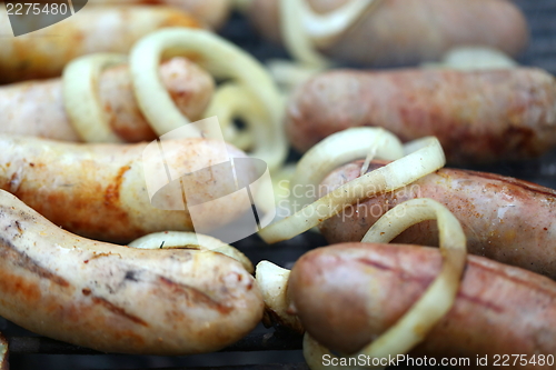 Image of BBQ a lot of sausages with onion