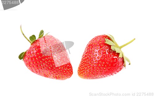 Image of two fresh red strawberries with leaves