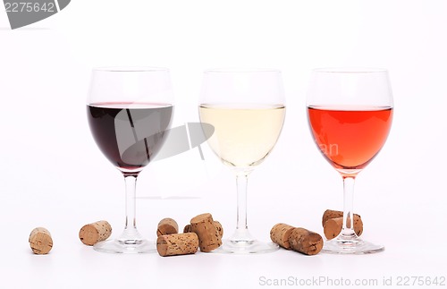 Image of Three wine glasses and corks.