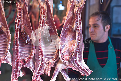 Image of butcher sells meat on the local market