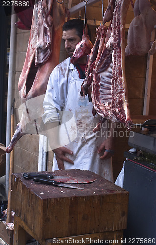 Image of butcher sells meat on the local market