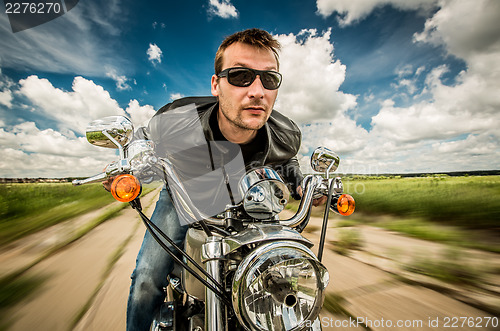 Image of Biker racing on the road