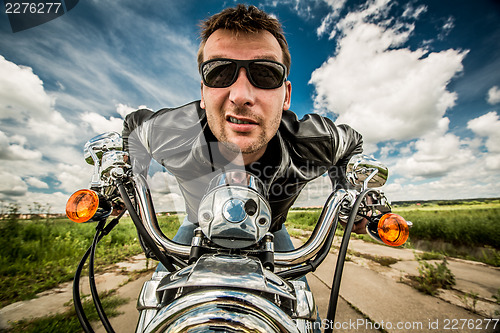 Image of Biker racing on the road