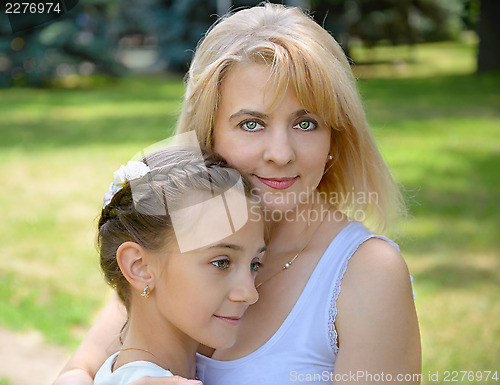 Image of Mother and daughter  is in garden