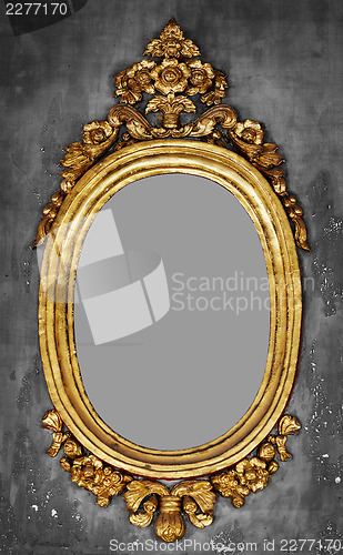 Image of Old-fashioned gilt frame for a mirror on a concrete wall