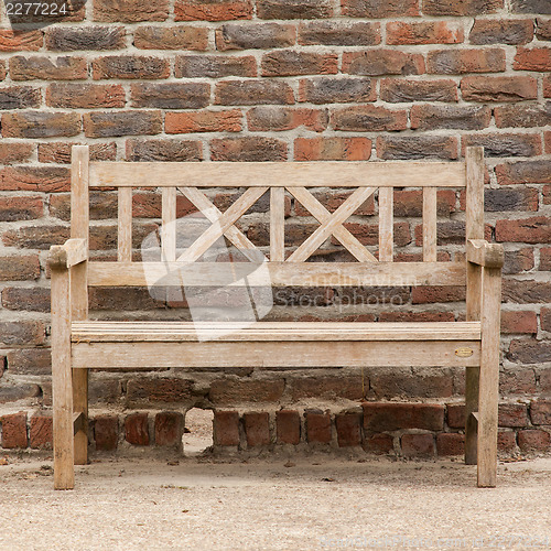 Image of Rugged, primitive wooden sidewalk bench beside multi-colored ver