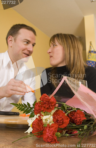 Image of happy couple cooking and kissing