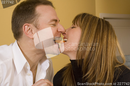 Image of happy couple cooking and kissing