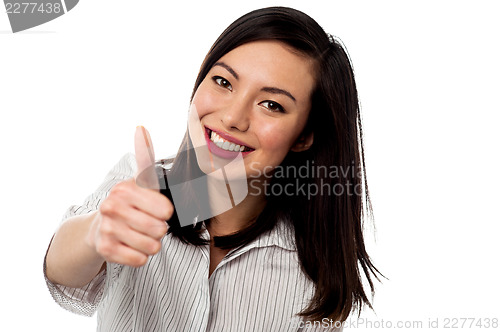 Image of Smiling young woman showing thumbs up