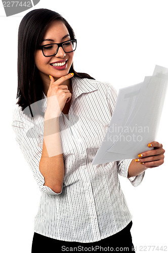 Image of Female analyzing annual business reports