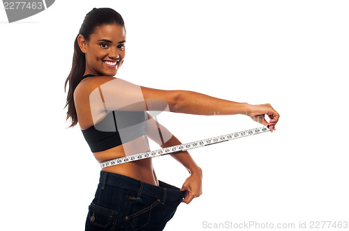 Image of Slim woman measuring her waist