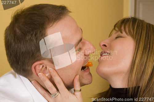 Image of happy couple cooking and kissing