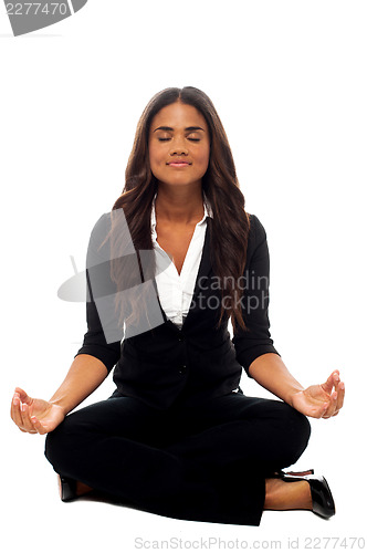 Image of Businesswoman meditating in lotus posture