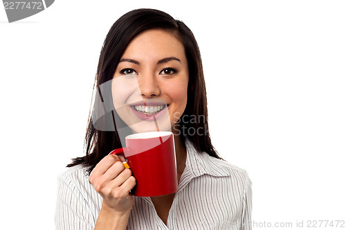 Image of Woman enjoying coffee during work break