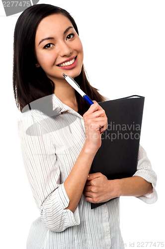 Image of Female executive holding business file and pen