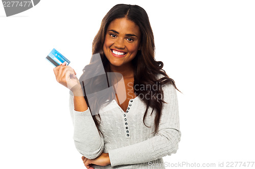 Image of Young woman holding up a credit card