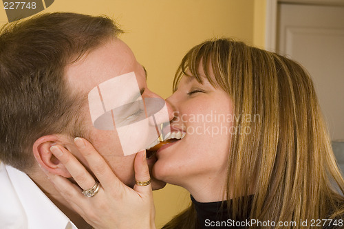 Image of happy couple cooking and kissing