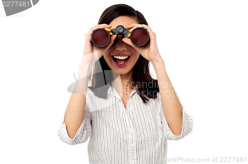 Image of Businesswoman enjoying view through binoculars