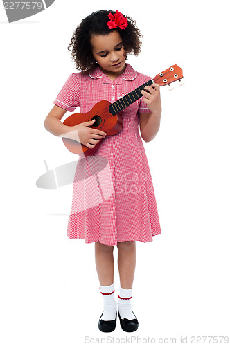 Image of Preschool cute girl playing a guitar