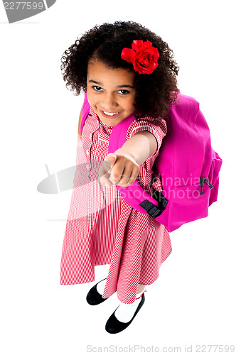 Image of Aerial view of cute girl pointing upwards