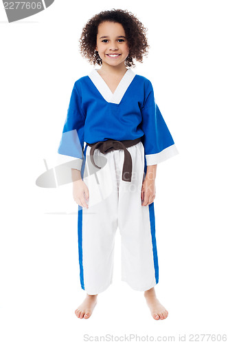 Image of Smiling young girl in karate uniform