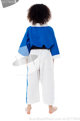 Image of Back pose of a small girl in karate uniform