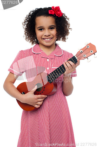 Image of A little girl with a toy guitar