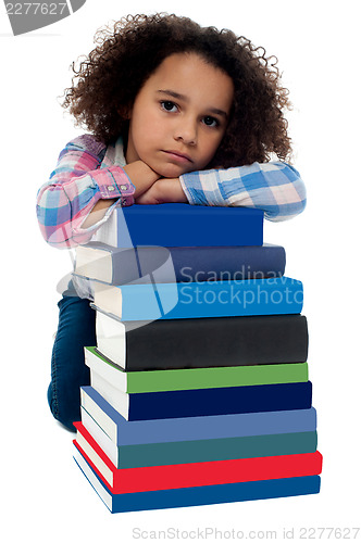 Image of Sad little girl bored of reading