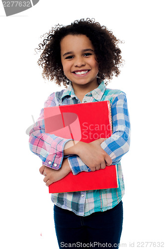 Image of Smiling schoolgirl holding a book