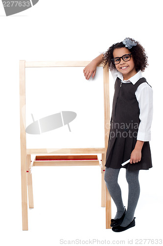 Image of Bright student resting her hand on whiteboard