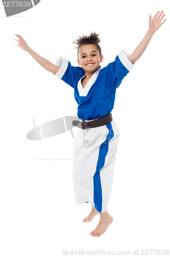 Image of Enthusiastic young girl kid in karate uniform