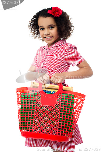 Image of Pretty child carrying math equipment's in basket