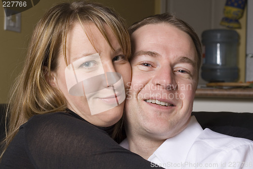 Image of happy couple relaxing on couch