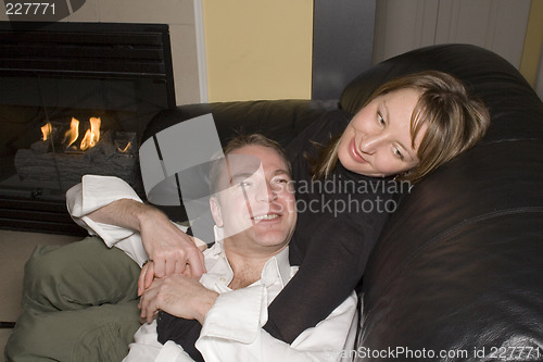 Image of happy couple relaxing on couch