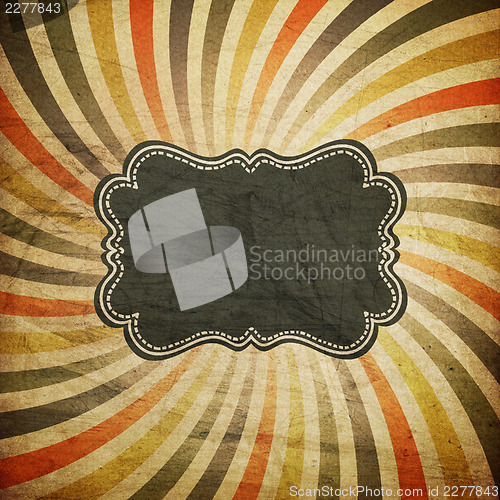 Image of Grunge colorful rays background with vintage label for text. 