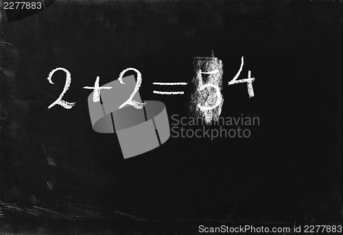 Image of Ooops. Simple math operation 2+2= writing chalk on blackboard.