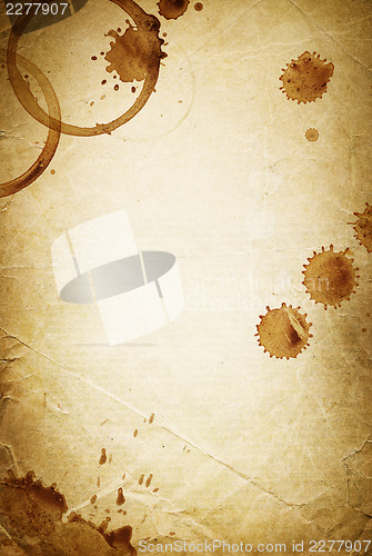 Image of Classic vintage background. Old paper sheet with drops of coffee