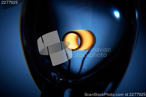 Image of Glower is heated. Conceptual shot of incandescent lamp in blue.