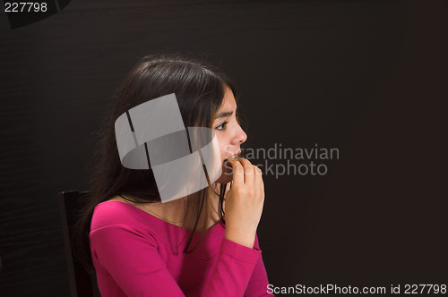 Image of teen posing over black backdrop