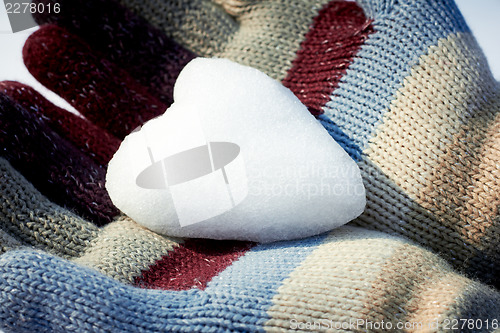 Image of Snow heart in woman hands