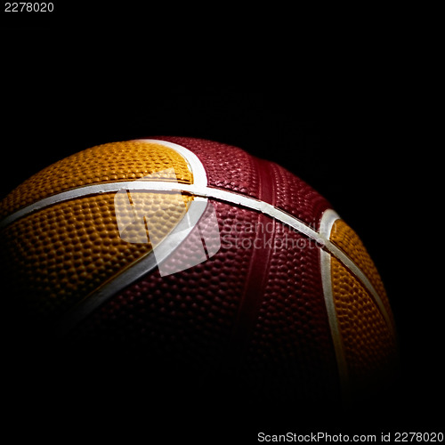 Image of Close-up of a basketball isolated on black background