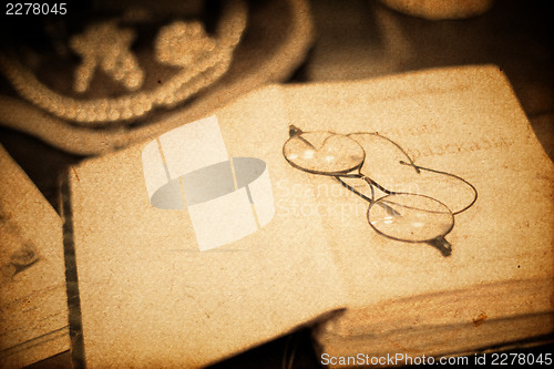 Image of Vintage book and glasses. Closeup shot, retro styled.