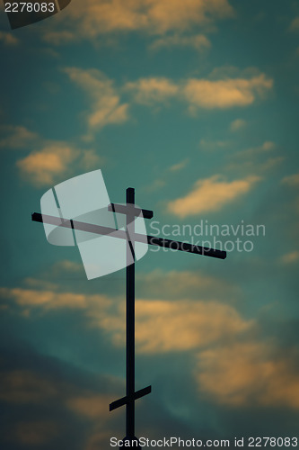 Image of Church cross with sunset sky in the background.