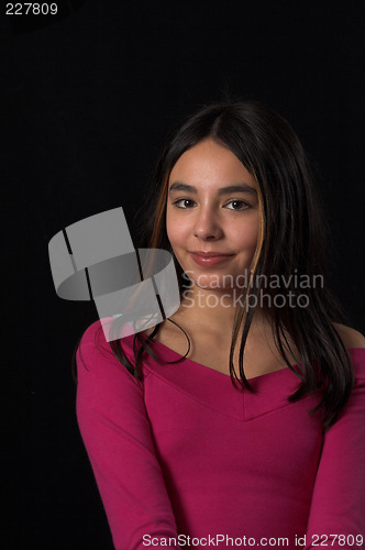 Image of teen posing over black backdrop