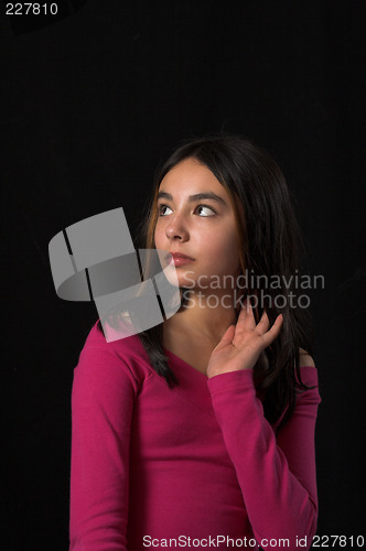 Image of teen posing over black backdrop