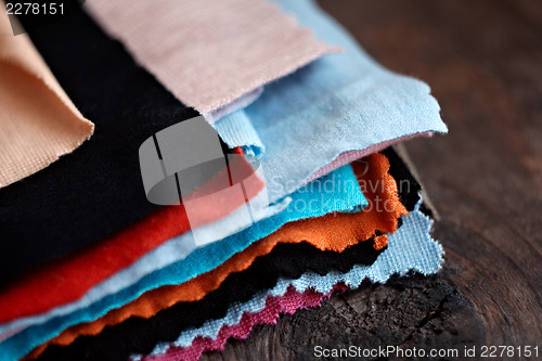 Image of Tissue colored materials, on wood background. Closeup shot.