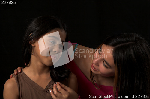 Image of teen posing over black backdrop